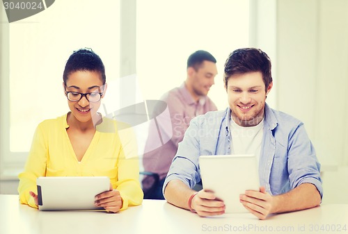 Image of smiling team with tablet pc computers at office