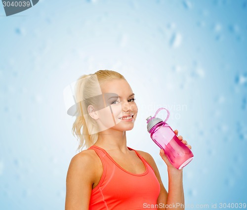 Image of smiling sporty woman with water bottle