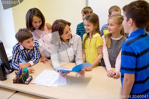 Image of group of school kids with teacher in classroom