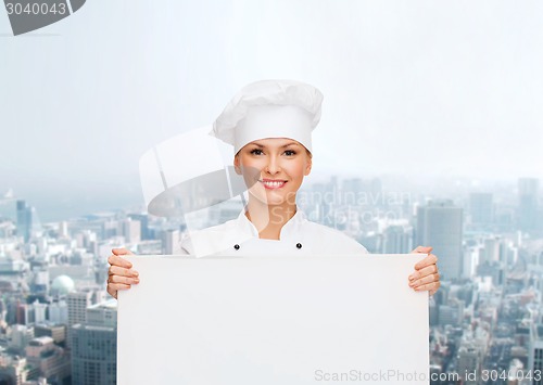 Image of smiling female chef with white blank board
