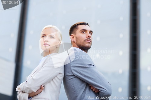 Image of businessman and businesswoman outdoors