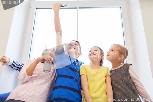 Image of group of school kids with smartphone and soda can