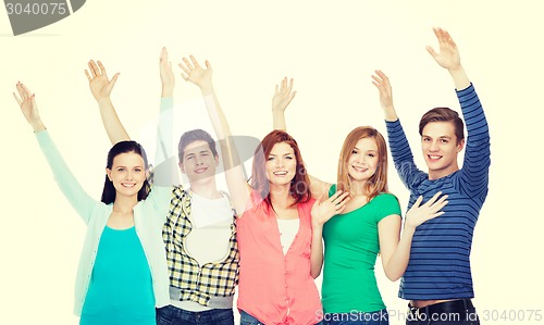 Image of group of smiling students waving hands