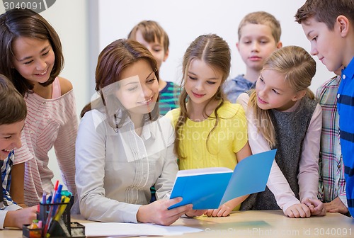 Image of group of school kids with teacher in classroom