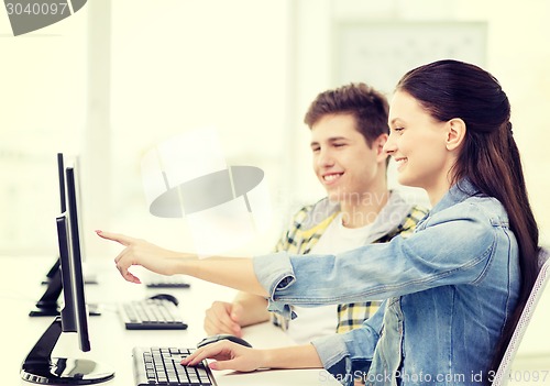 Image of two smiling students in computer class