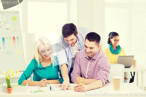 Image of smiling interior designers working in office