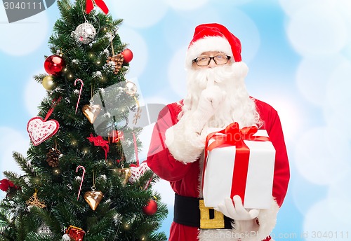 Image of man in costume of santa claus with gift box