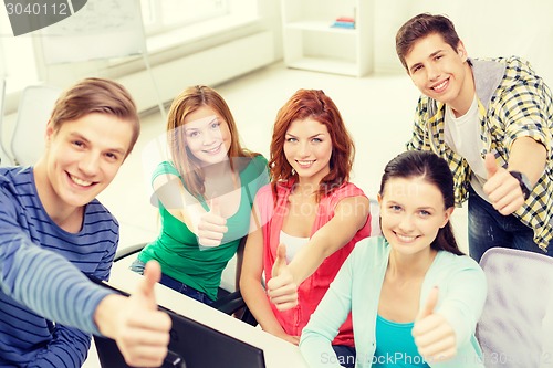 Image of group of smiling students showing thumbs up