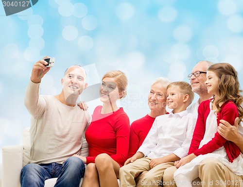 Image of smiling family with camera