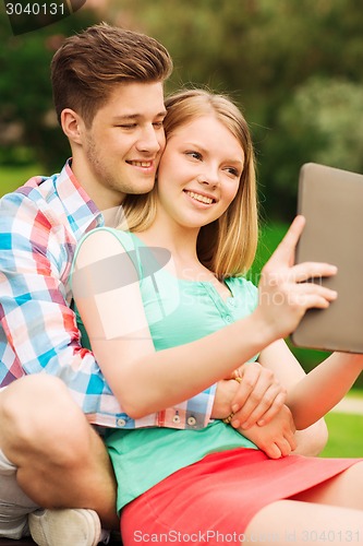 Image of smiling couple with tablet pc making selfie