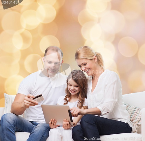 Image of happy family with tablet pc and credit card