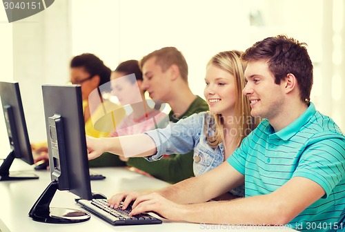 Image of smiling students in computer class at school