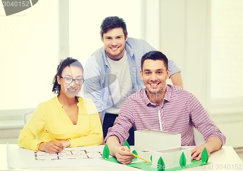 Image of smiling architects working in office