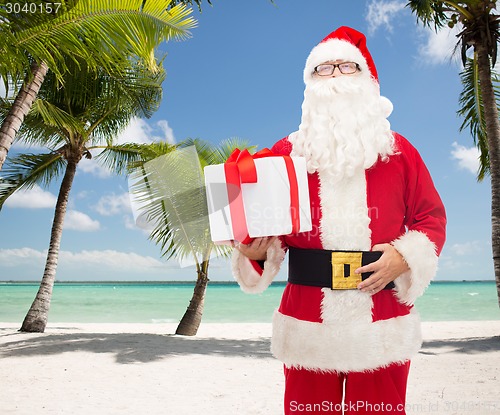 Image of man in costume of santa claus with gift box