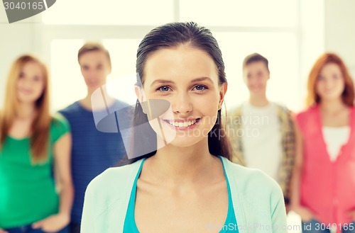 Image of smiling students with teenage girl in front