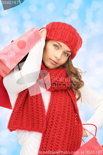 Image of smiling young woman with shopping bags