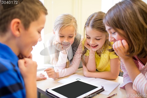 Image of group of school kids with tablet pc in classroom