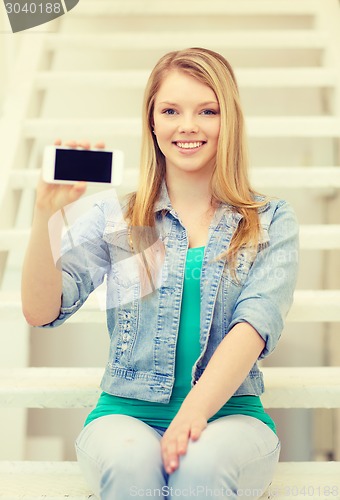 Image of smiling student with smartphone blank screen