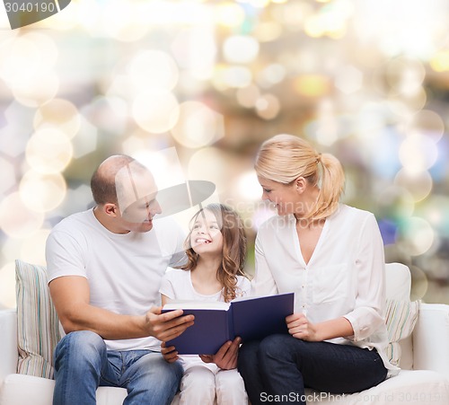 Image of happy family with book at home