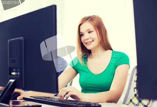 Image of smiling female student in computer class