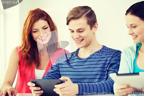 Image of smiling students with tablet pc at school