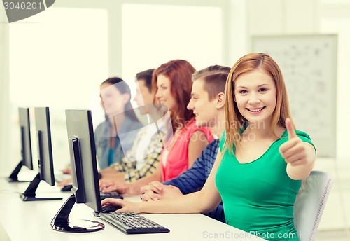 Image of female student with classmates in computer class