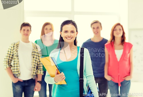 Image of smiling students with teenage girl in front