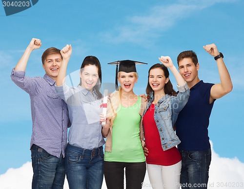 Image of group of standing smiling students with diploma