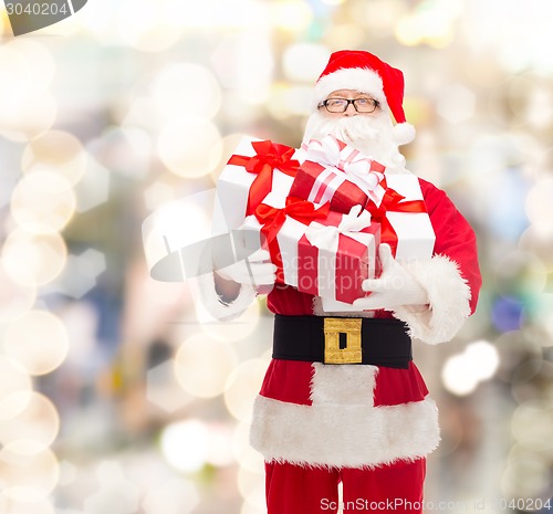 Image of man in costume of santa claus with gift boxes