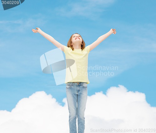 Image of smiling teenage girl with raised hands