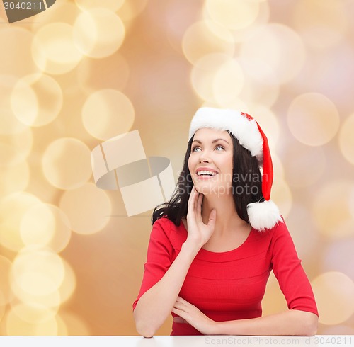 Image of smiling woman in santa helper hat