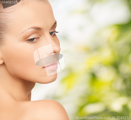 Image of beautiful young woman over green background