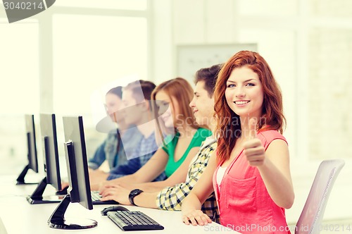 Image of female student with classmates in computer class