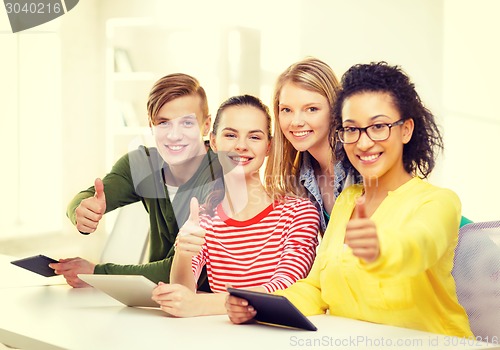 Image of smiling students with tablet pc at school