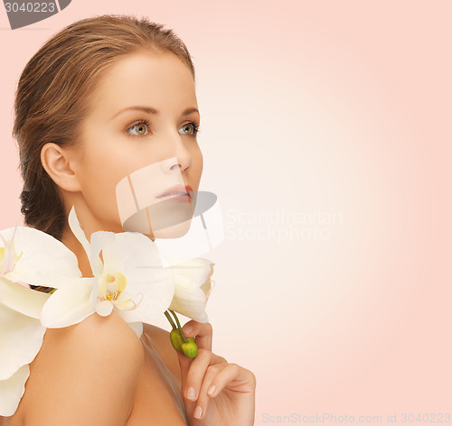 Image of beautiful young woman with orchid flowers