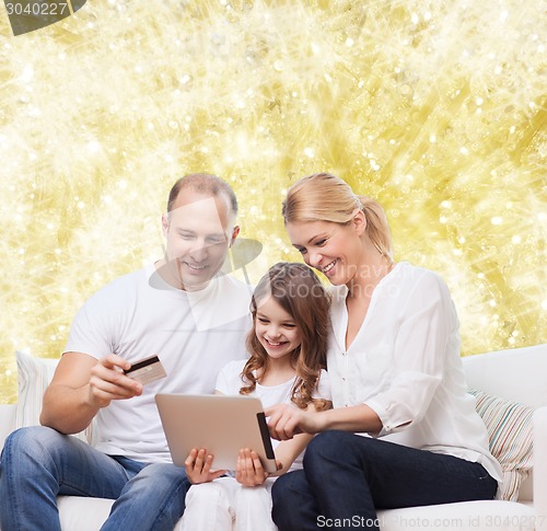 Image of happy family with tablet pc and credit card