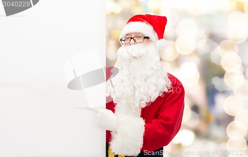 Image of man in costume of santa claus with billboard