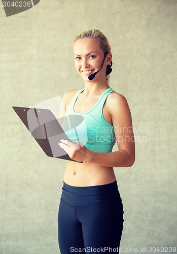 Image of beautiful athletic woman in gym