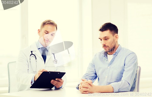 Image of doctor with clipboard and patient in hospital