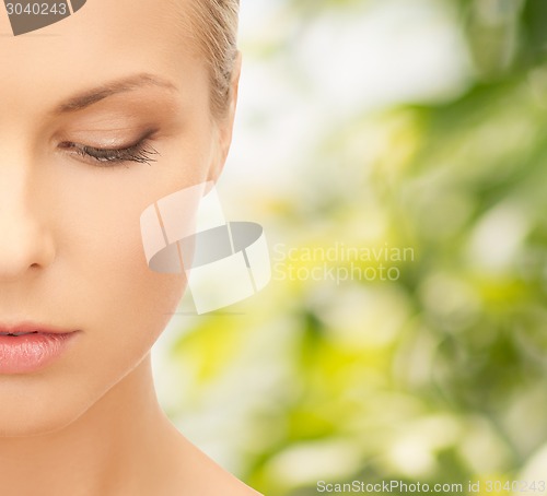 Image of beautiful young woman over green background