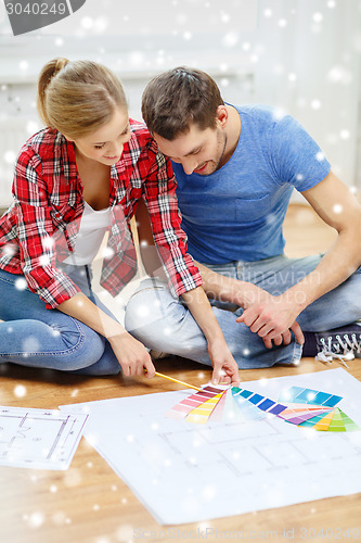 Image of smiling couple selecting color from samples