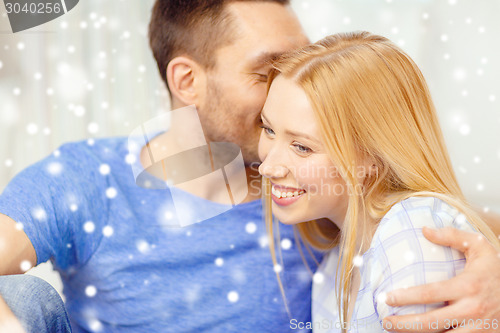 Image of happy couple hugging at home