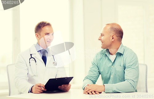 Image of doctor with clipboard and patient in hospital