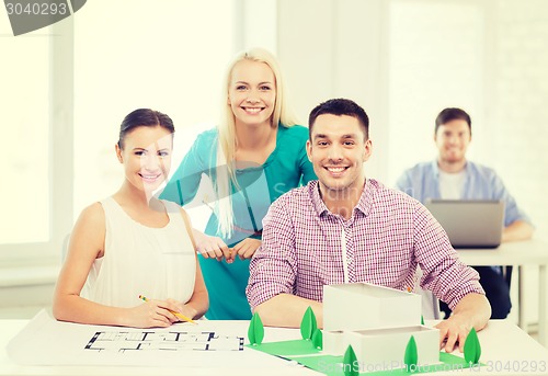 Image of smiling architects working in office