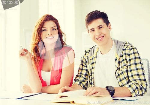 Image of students with textbooks and books at school