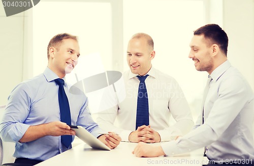 Image of business team working with tablet pc in office