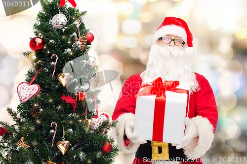 Image of man in costume of santa claus with gift box