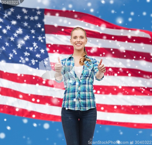 Image of smiling girl in casual clothes showing thumbs up