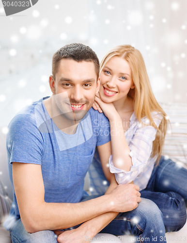Image of happy couple hugging at home