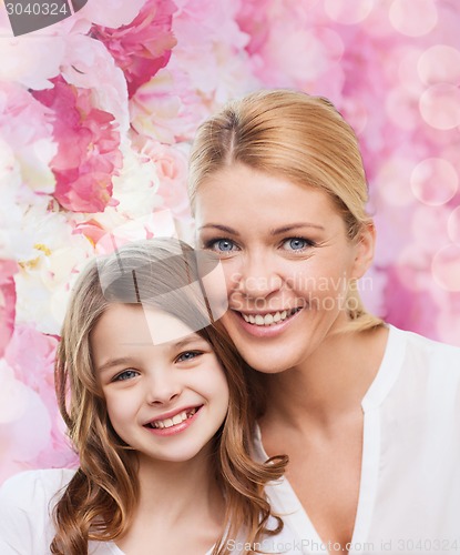 Image of smiling mother and little girl